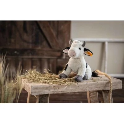 Peluche vache Cobb - 24 cm signée Steiff sur une table en bois Peluche vache Cobb - 24 cm signée Steiff sur une table en bois
