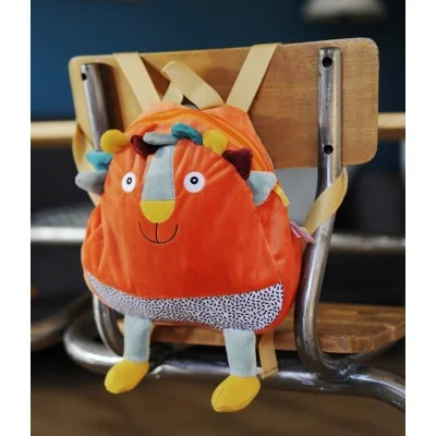 Sac à dos Woogy le lion signé Ebulobo accroché à une chaise Sac à dos Woogy le lion signé Ebulobo accroché à une chaise
